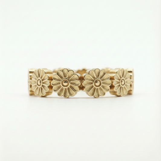 Gold floral ring on a white background
