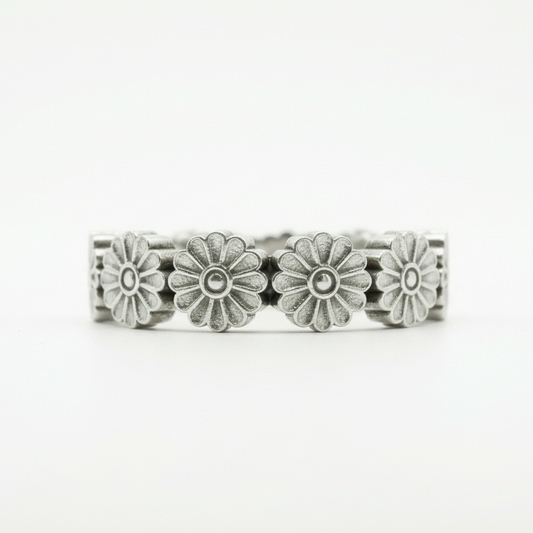 Silver floral ring on a white background