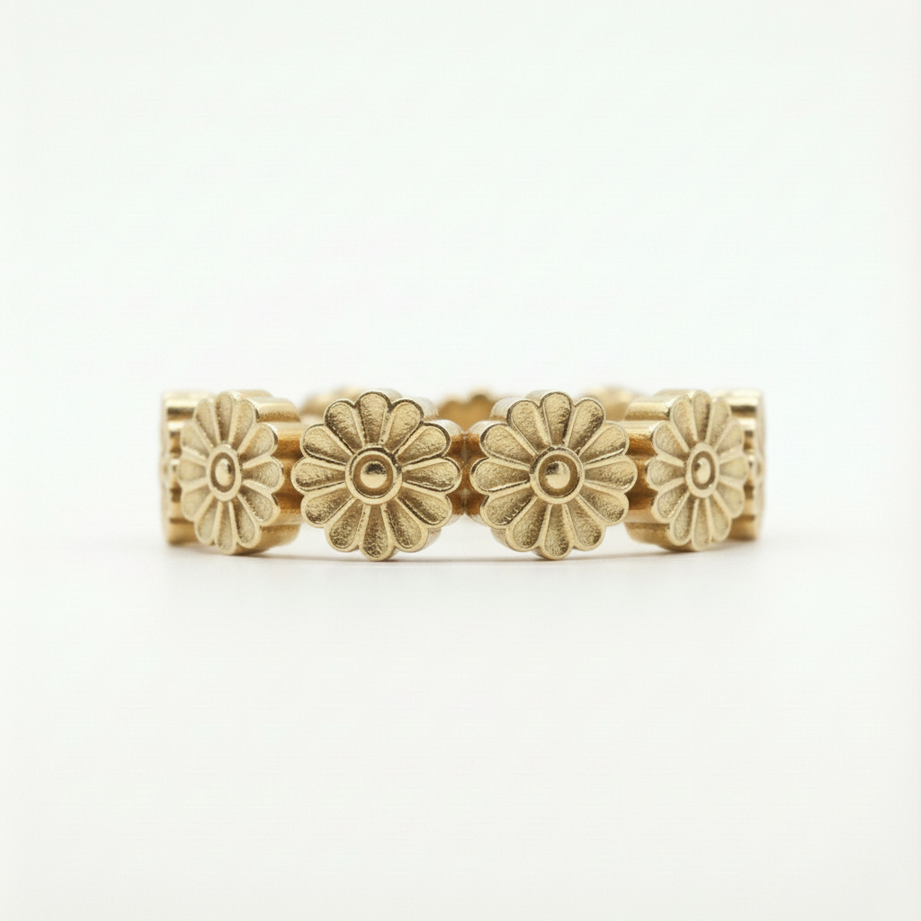 Gold floral ring on a white background
