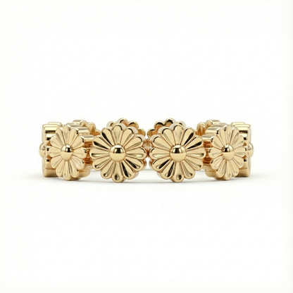Gold ring with floral designs on a white background