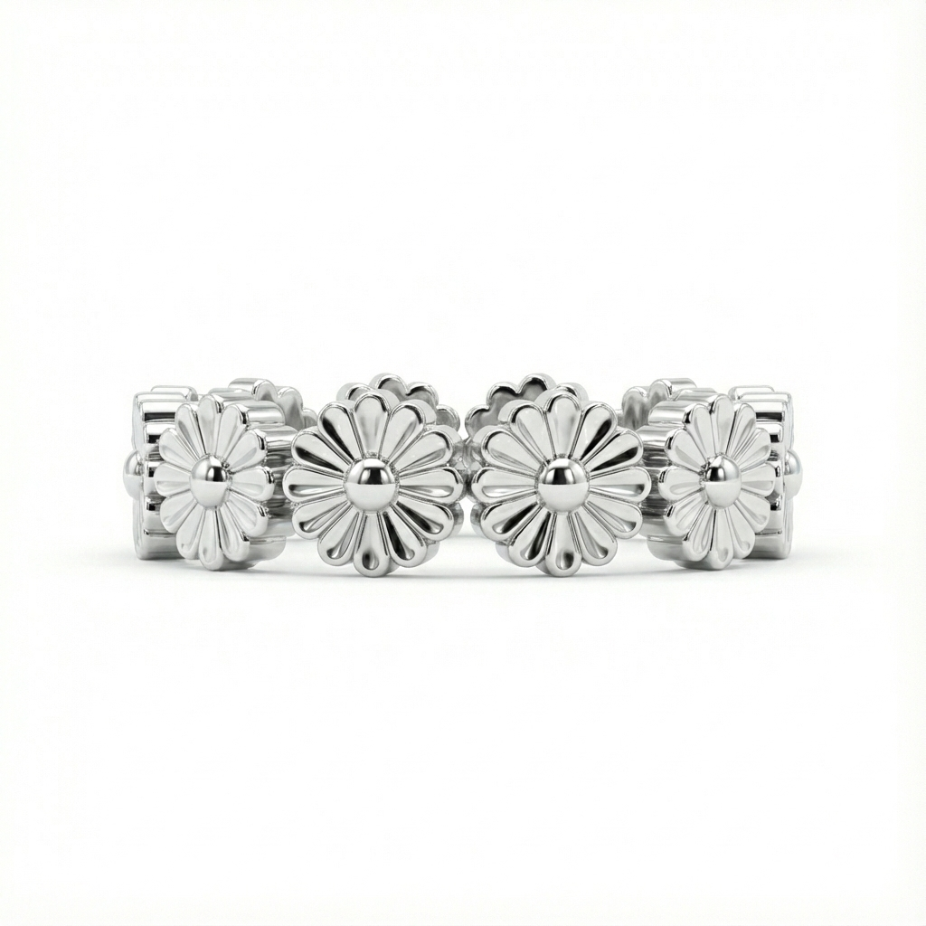 Silver ring with floral designs on a white background