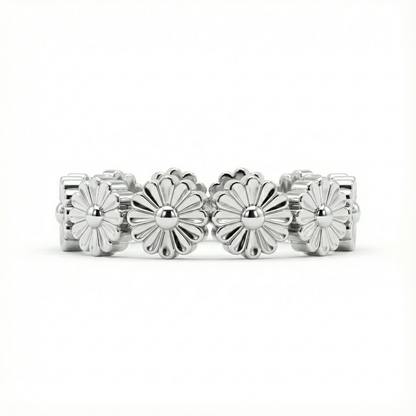 Silver ring with floral designs on a white background